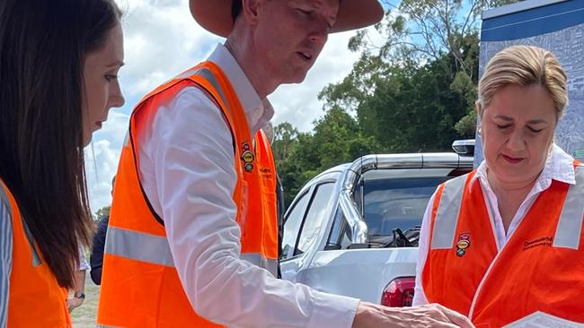 Environment Minister Meaghan Scanlon and Transport Minister Mark Bailey, looking at maps for the Coomera Connector with Premier Annastacia Palaszczuk.