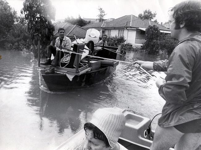 Owners of small boats helping residents salvage some goods from their flooded homes