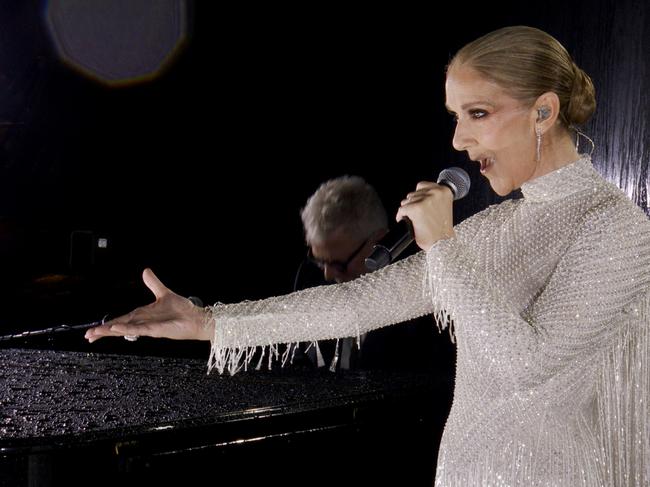 Celine Dion performing on the Eiffel Tower in a specially made haute couture Dior gown. Picture: IOC via Getty Images