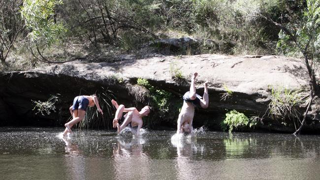 Locals cool off in the Georges River at Simmo's Beach Reserve, Macquarie Fields.