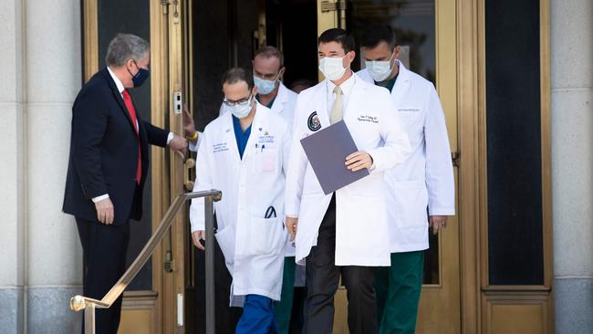 Acting White House Chief of Staff Mark Meadows holds the door for Sean Conley (front C), Physician to Donald Trump, and other members of the President's medical team as they arrive to give an update on the President's health. Picture: AFP.