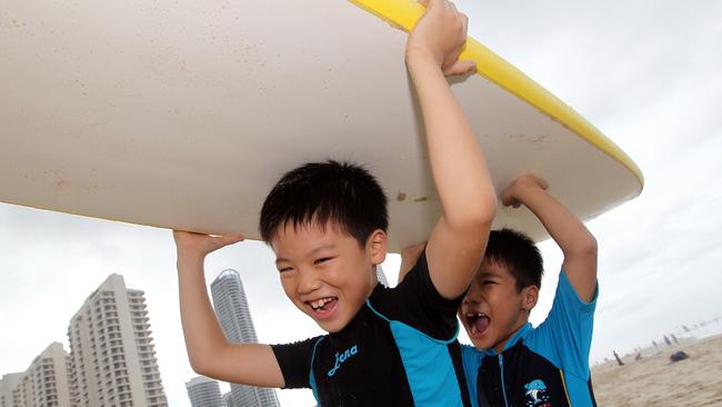 The number of Japanese tourists visiting the Gold Coast climbed 18 per cent to 66,500 for the 12 months to March. Japanese brothers Tatsuki, 8, and Naruki Kakuta, 6, enjoy Surfers Paradise Beach. Picture: Adam Head