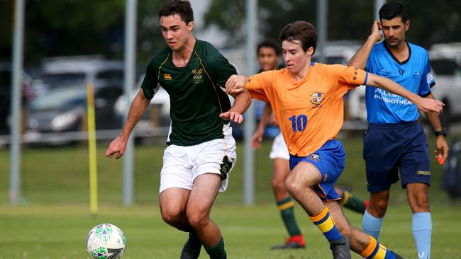 Villanova College's Will Kubler (left, in green) and Marist College Ashgrove’s Sam Vosper (right, in gold) during their First XI clash in 2019. Photo: David Clark – AAP.