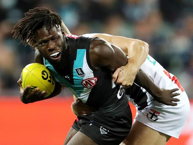 ADELAIDE, AUSTRALIA - APRIL 25: Martin Frederick of the Power is tackled by Dan Butler of the Saints during the 2021 AFL Round 06 match between the Port Adelaide Power and the St Kilda Saints at Adelaide Oval on April 25, 2021 in Adelaide, Australia. (Photo by Sarah Reed/AFL Photos via Getty Images)