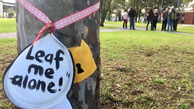 A sign wrapped around a tree in Gandolfo Gardens in Coburg.