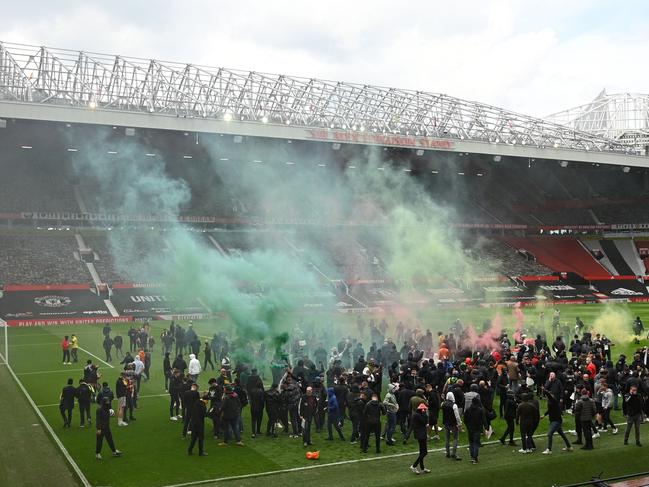 TOPSHOT - Supporters protest against Manchester United's owners, inside English Premier League club Manchester United's Old Trafford stadium in Manchester, north west England on May 2, 2021, ahead of their English Premier League fixture against Liverpool. - Manchester United were one of six Premier League teams to sign up to the breakaway European Super League tournament. But just 48 hours later the Super League collapsed as United and the rest of the English clubs pulled out. (Photo by Oli SCARFF / AFP)
