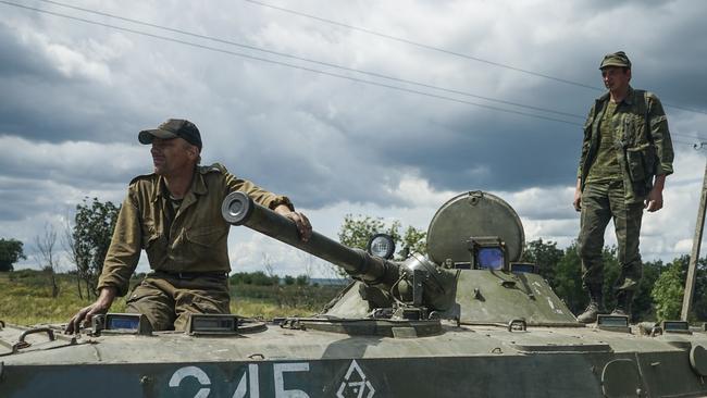 Nightmare ... Russian-backed rebels guard the crash site of the Malaysian Airlines MH17 plane near the village of Hrabove, eastern Ukraine.