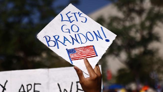 A protester holds a 'Let's Go Brandon!' sign during an anti-Covid mandate rally in Los Angeles on Monday. Picture: Getty Images