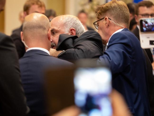 Sam Husseini is escorted from the press conference room by Finnish secret service agents. Picture: Chris McGrath/Getty Images.