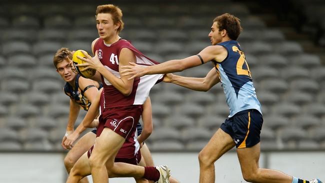 Andrews attempts to break the tackle of his under-18 NSW/ACT opponent in 2014. Picture: Lachlan Cunningham/AFL Media