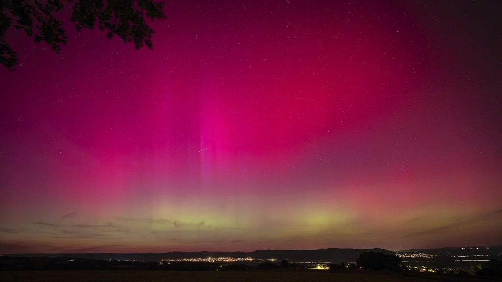 People stop along a country road near London, Ontario, to watch the Northern Lights, or Aurora Borealis, during a geomagnetic storm