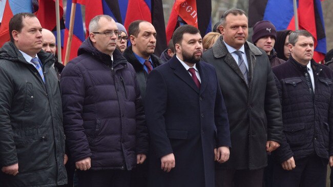 Separatist leader of the Donetsk region, Denis Pushilin (centre) with Prizm cryptocurrency founder Alexi Muratov at left.