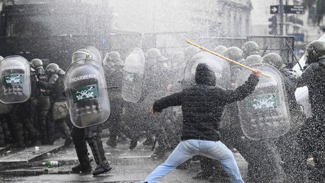 If you fail to calibrate the reforms, bringing the electorate along with you, you run the risk of things coming off the rails. Milei runs this risk. A demonstrator is pictured clashing with riot police outside the National Congress. Picture: AFP