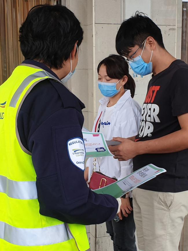 Strathfield Council staff handing out social distancing flyers.