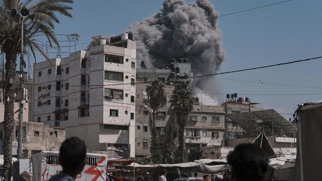 Smoke rises in the sky following an Israeli airstrike in Gaza City, Friday, May 30, 2025. (AP Photo/Jehad Alshrafi)