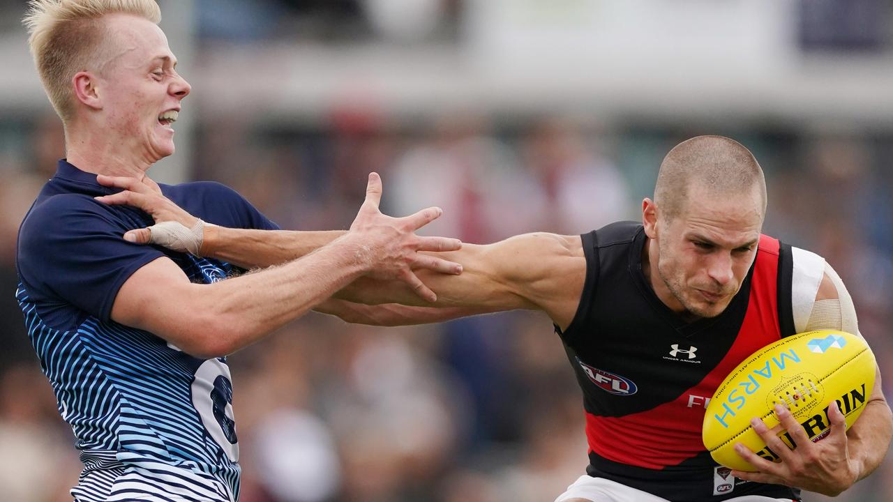 David Zaharakis of the Bombers fends off Zach Guthrie of the Cats.