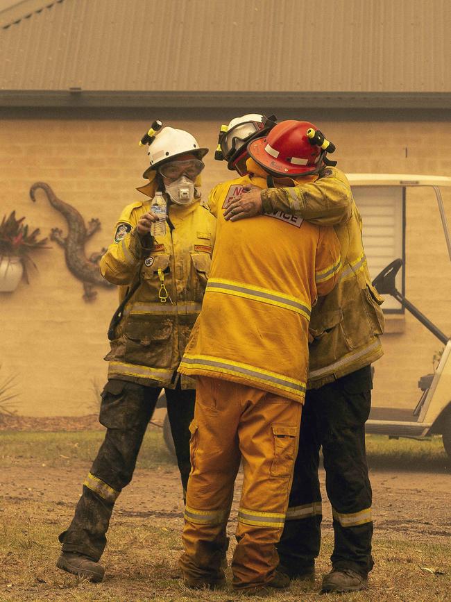 Bawley Point RFS captain Dave Sharpe (Red Helmet) was overcome with emotion as his colleagues helped him extinguish a blaze surrounding his home. Picture Gary Ramage