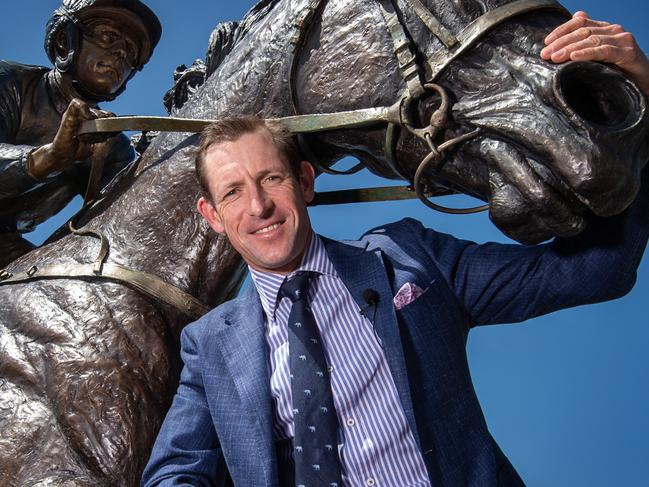 WARNING Under strict embargo until Saturday. A sneak peek of the Winx statue that will be unveiled at Moonee Valley on Cox Plate Day. Jockey Hugh Bowman poses up with the statue Picture: Tony Gough