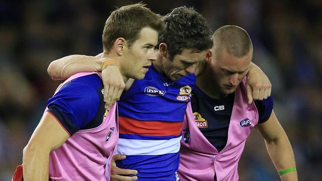 Bob Murphy is helped from the field after rupturing his ACL earlier this season. Picture: Wayne Ludbey