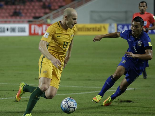 Aaron Mooy of Australia, left, and Adison Promrak of Thailand.