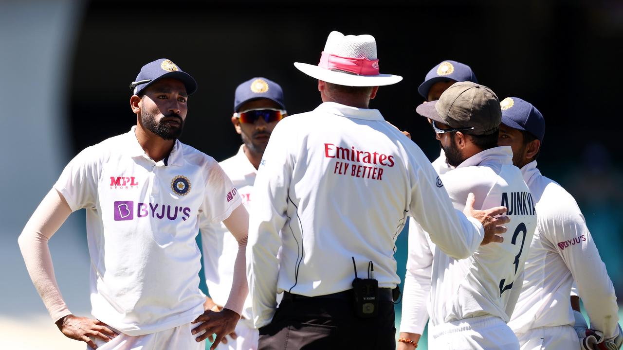 Mohammed Siraj and captain Ajinkya Rahane speak to umpire Paul Reiffel.