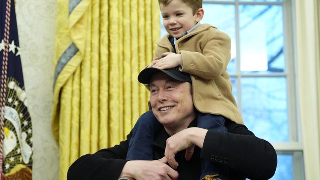 Mr Musk answering questions with his young son on his shoulders. Picture: Alex Brandon