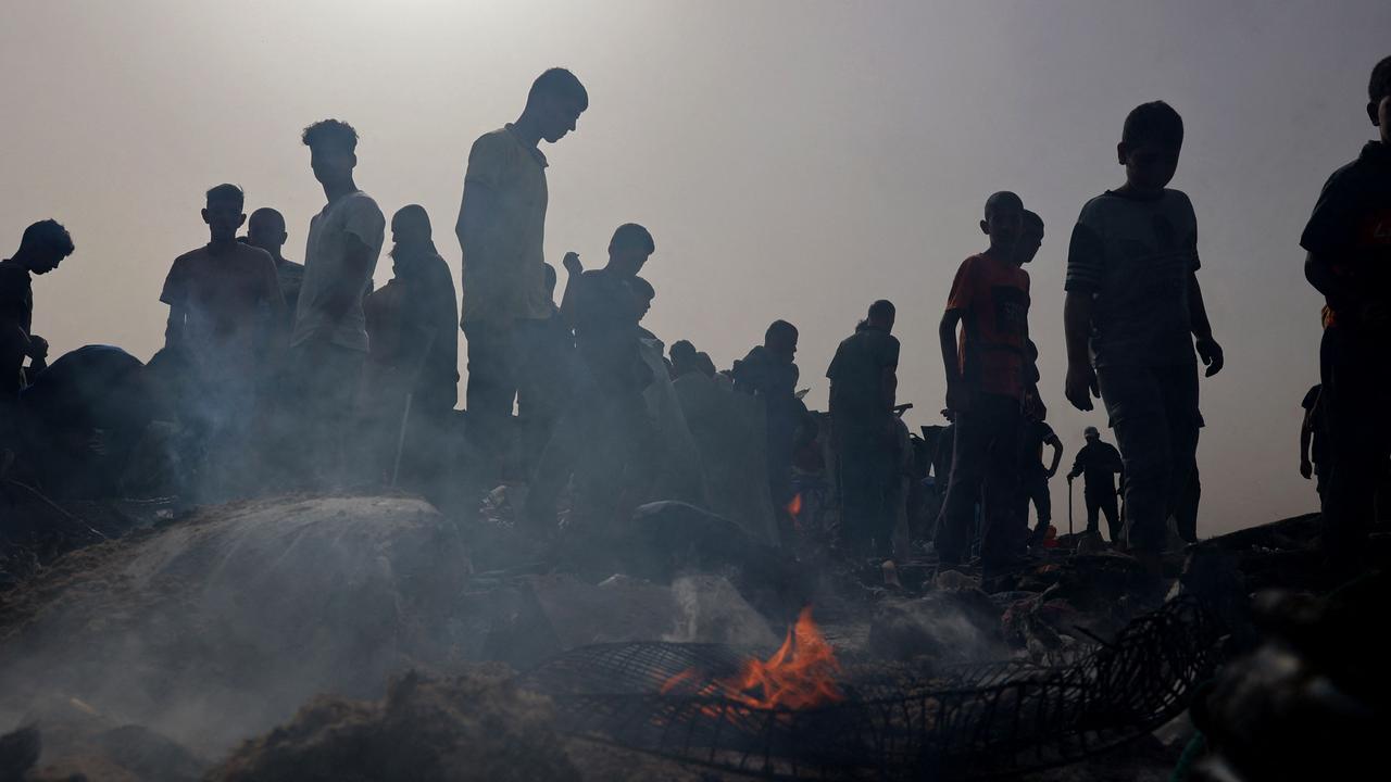 Palestinians gather at the site of an Israeli strike on a camp for internally displaced people in Rafah on May 27, 2024. (Photo by Eyad BABA / AFP)