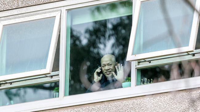 A resident waves and makes a phone call. Picture: Tim Carrafa