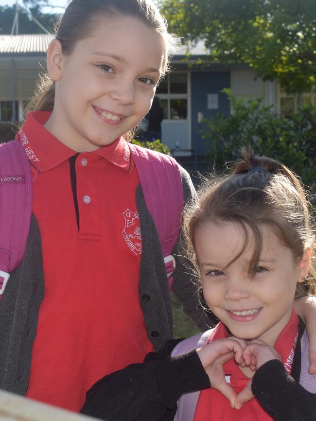 Gympie West State School student Amali Turner (Year 5) was happy to finally join her younger sister Ella Turner (Prep) at school yesterday. Picture: Frances Klein