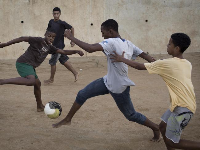 Residents play at the Sao Carlos slum in Rio de Janeiro.