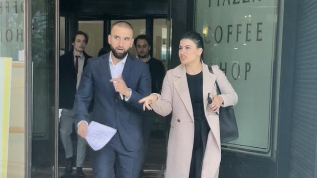 Ariz Rahimi (left) leaves Downing Centre Local Court after facing an assault charge