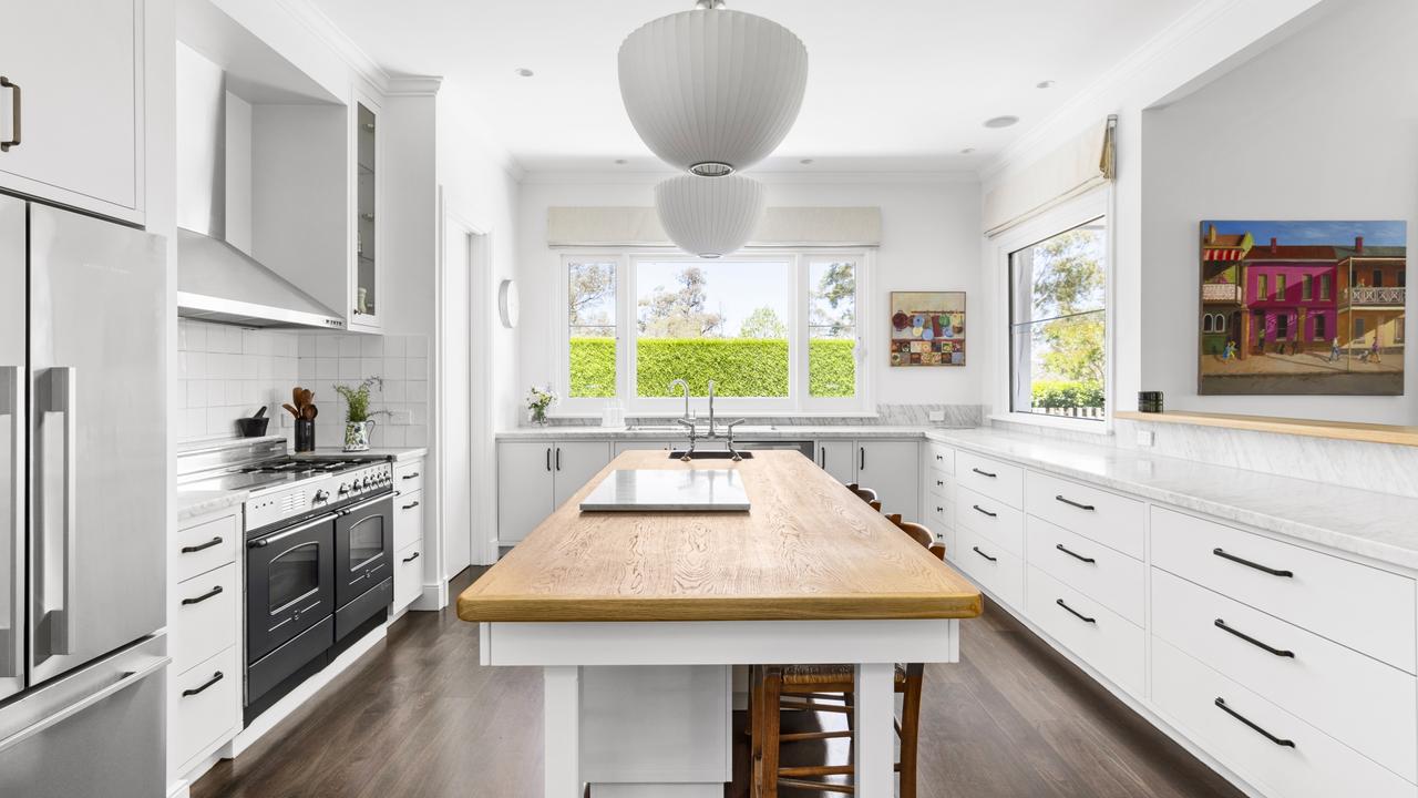 The kitchen has marble benchtops and an American oak island.