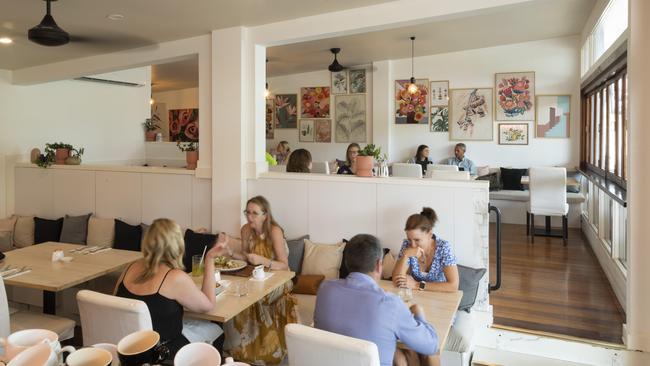 The interior at Maude in Coorparoo boasts a gallery wall of floral art. Picture: Mark Cranitch.