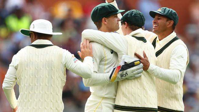 Alex Carey and Steve Smith celebrate winning on day four of the second Test at Adelaide Oval. Picture: Chris Hyde/Getty Images