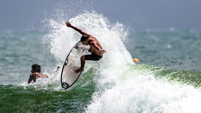 A Surfer gets some air at Snapper Rocks. Picture: Nigel Hallett