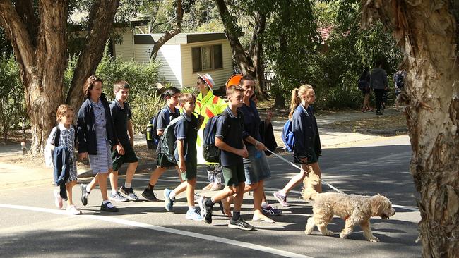 Students using a crossing that is scheduled to be closed. Picture: Hamish Blair