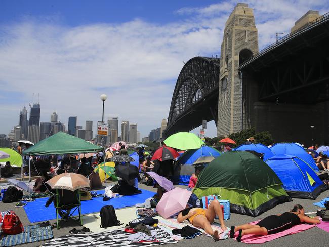People settling in at Milsons Point for tonight's New Years Eve celebrations in Sydney. Picture: Dylan Robinson