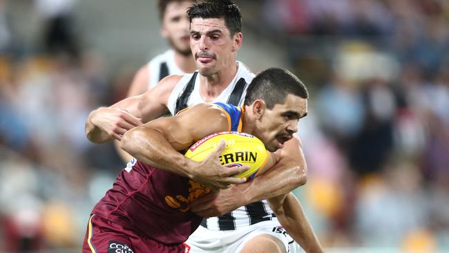 Charlie Cameron is tackled by Scott Pendlebury during the Lions’ loss to Collingwood in Round 5. Picture: Getty Images