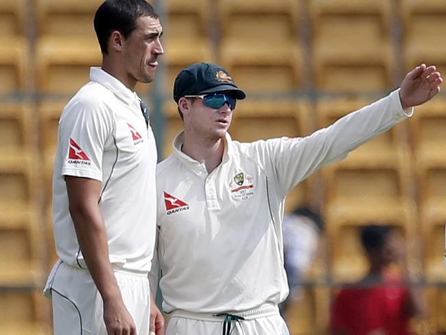 Australian captain Steve Smith has a discussion with teammate Mitchell Starc.
