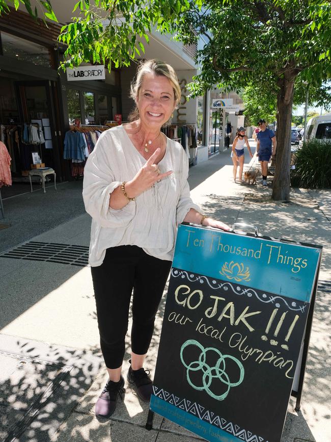 Sign board in Barwon Heads Go Jak with Ten Thousand Things worker Peitria Wooding and sign. Picture: Mark Wilson