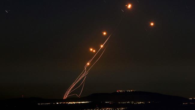 Rockets fired from southern Lebanon are intercepted by Israel's Iron Dome over the Upper Galilee region. Picture: AFP.