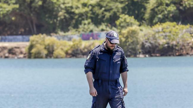 NSW Police Public Order and Riot Squad members search the banks of the Tweed River for evidence relating to the death of a nine-month-old baby who washed up on Surfers Paradise beach last week. (AAP Image/Tim Marsden)