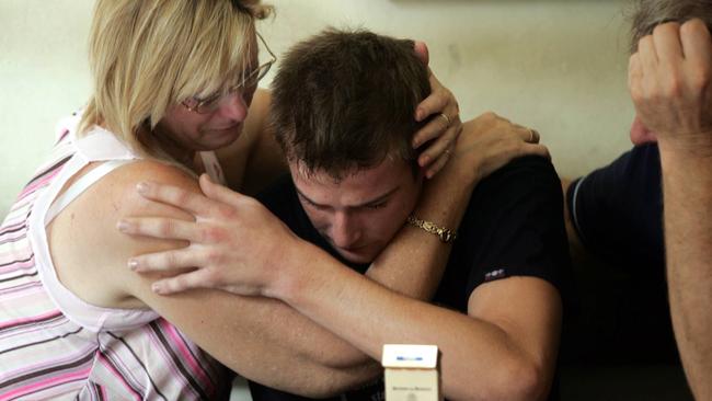 Czugaj, 19, weeps openly as his parents visit him for the first time at Police Headquarters in Denpasar.