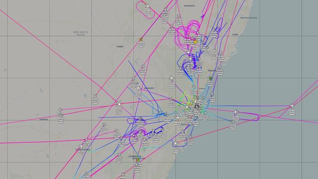 Flight radar image of Sydney Airport at about 10am Monday morning showing numerous flights in holding patterns due to restricted runway access. Picture: AussieADSB.com