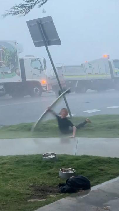 The moment a surfer's board was whipped away by fierce storm