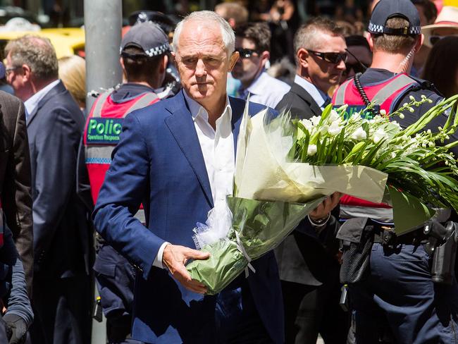 Prime Minister Malcolm Turnbull lays a floral tribute for the victims of the Bourke Street attack in Melbourne. Picture: Paul Jeffers / Getty Images