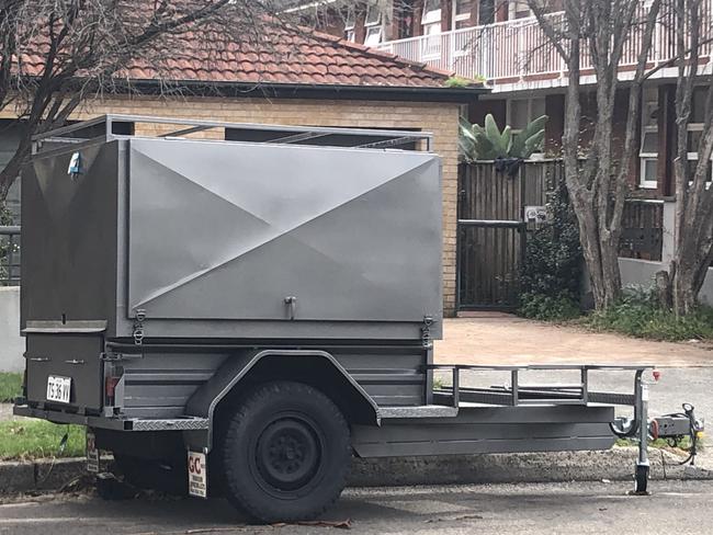 A trailer parked in Dee Why Pde, Dee Why. Locals complain that tradies are using the trailers as de facto streetside storage facilities. Picture: Jim O’Rourke