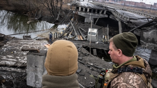 Ukrainian soldiers at a collapsed bridge which was the target of a Russian missile, near the town of Irpin, Ukraine. Picture: Wolfgang Schwan/Anadolu Agency via Getty Images