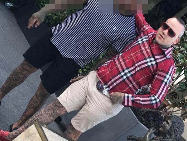 Rymer in his designer red loafers with a tattooed friend after his jail release.