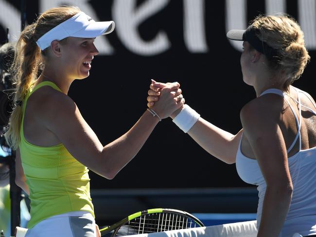 And the winner is ... Denmark's Caroline Wozniacki (left) shakes hands with Croatia's Jana Fett after winning their second-round match. Picture: AFP